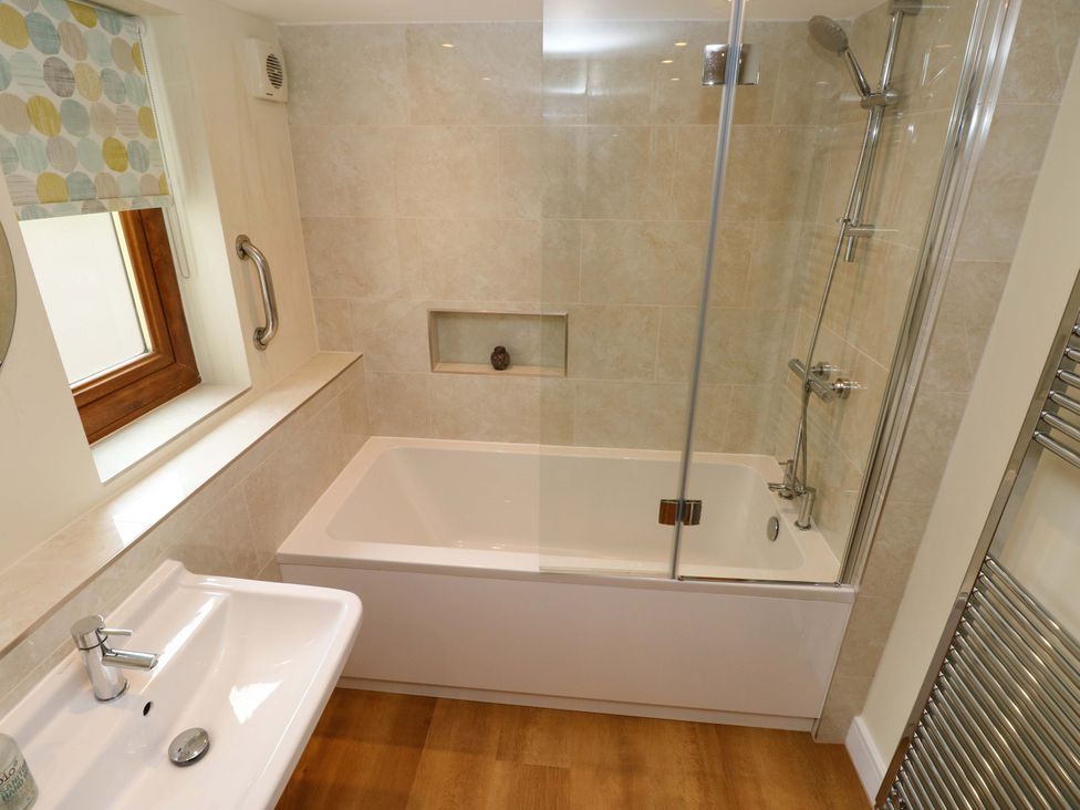 A bathroom with a bathtub and shower at Brynawelon Newport, Pembrokeshire