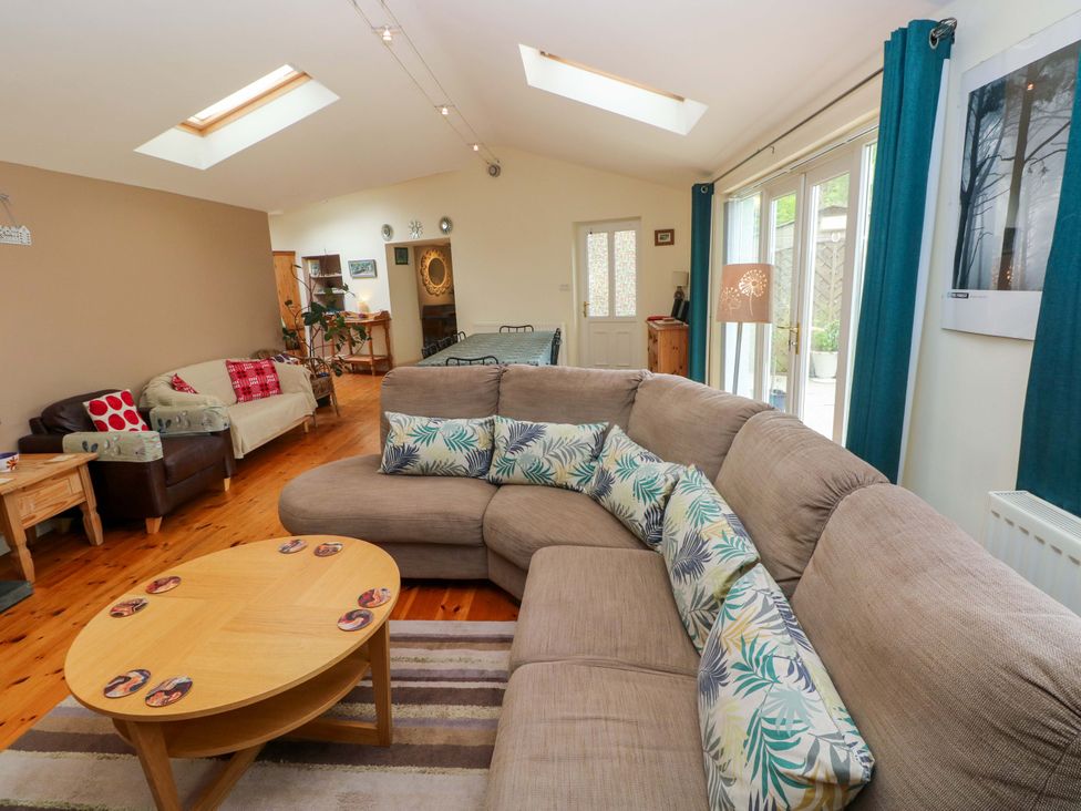 A living room with sofas and a coffee table at Greenbanks in Dinas Cross, Pembrokeshire