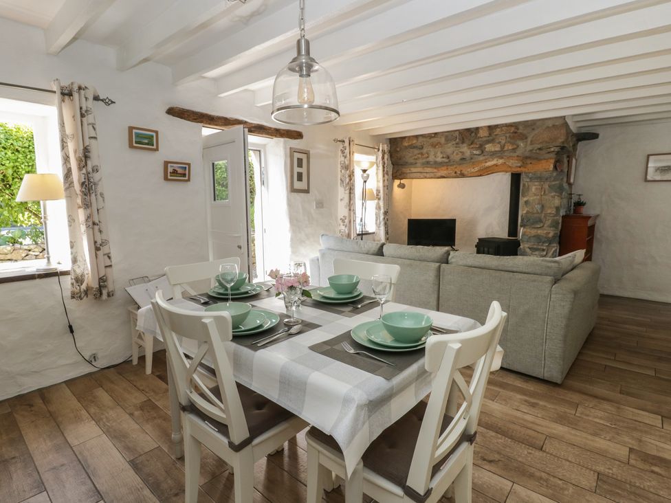 A dining room with a table and chairs at Middle Cottage Newport, Pembrokeshire