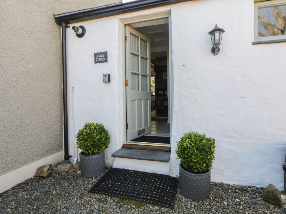 An entrance with a door and bushes at Middle Cottage Newport, Pembrokeshire
