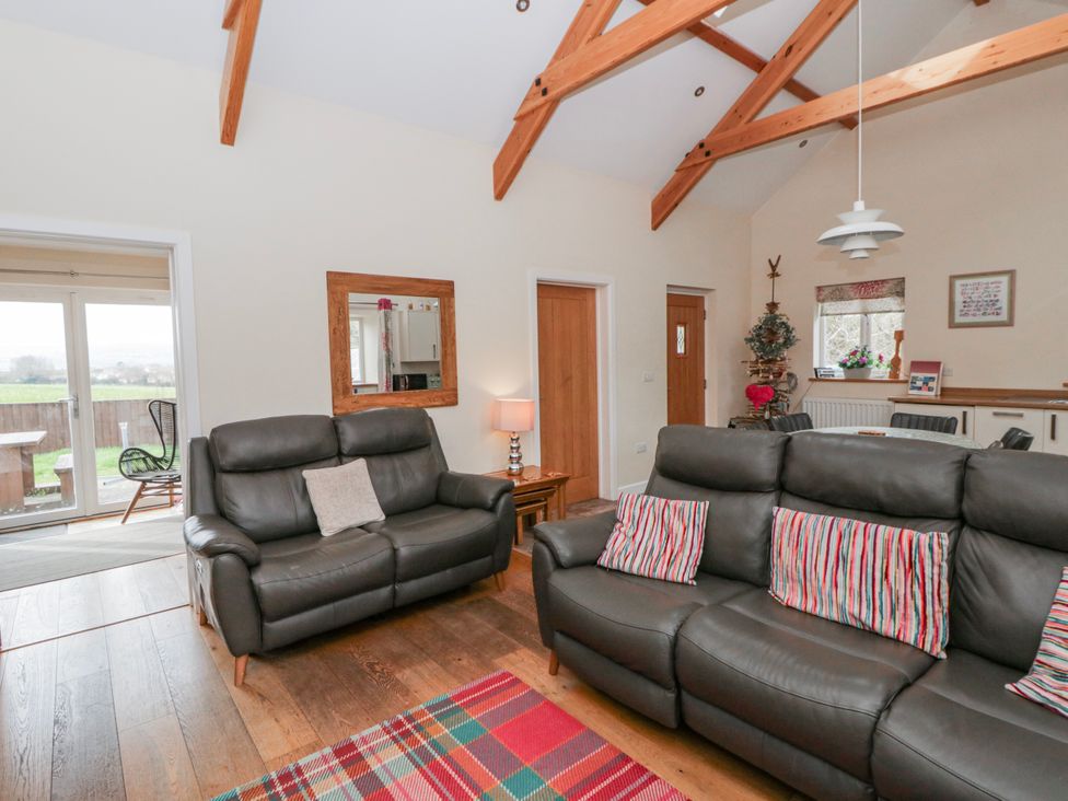 A living room with sofas and a coffee table at Y Felin in Cardigan, Ceredigion