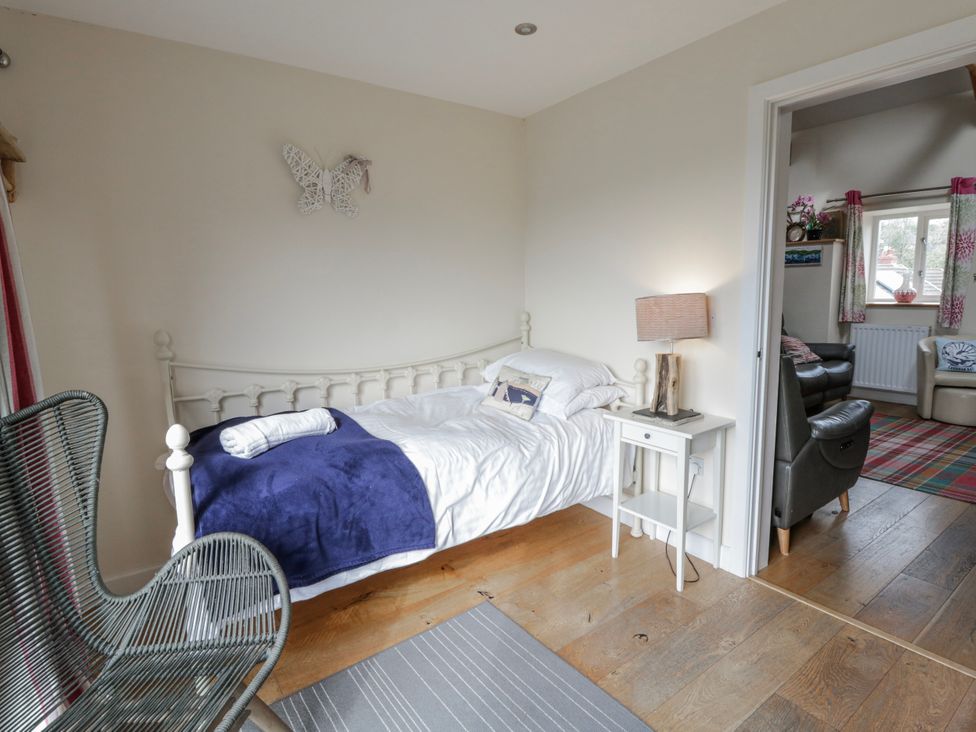 A bedroom with a bed and bedside table at Y Felin, Cardigan, Ceredigion