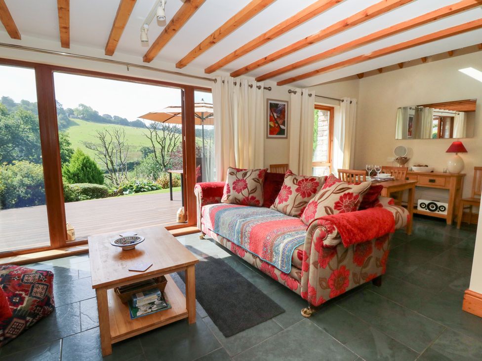 A living room with a sofa and coffee table at Dan Castell Cottage in Llandeilo, Carmarthenshire