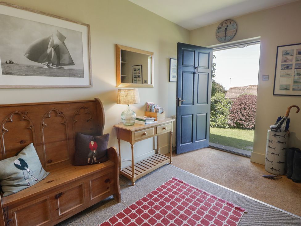 An entrance hall with a bench and table at Dolwylan in Newport, Pembrokeshire