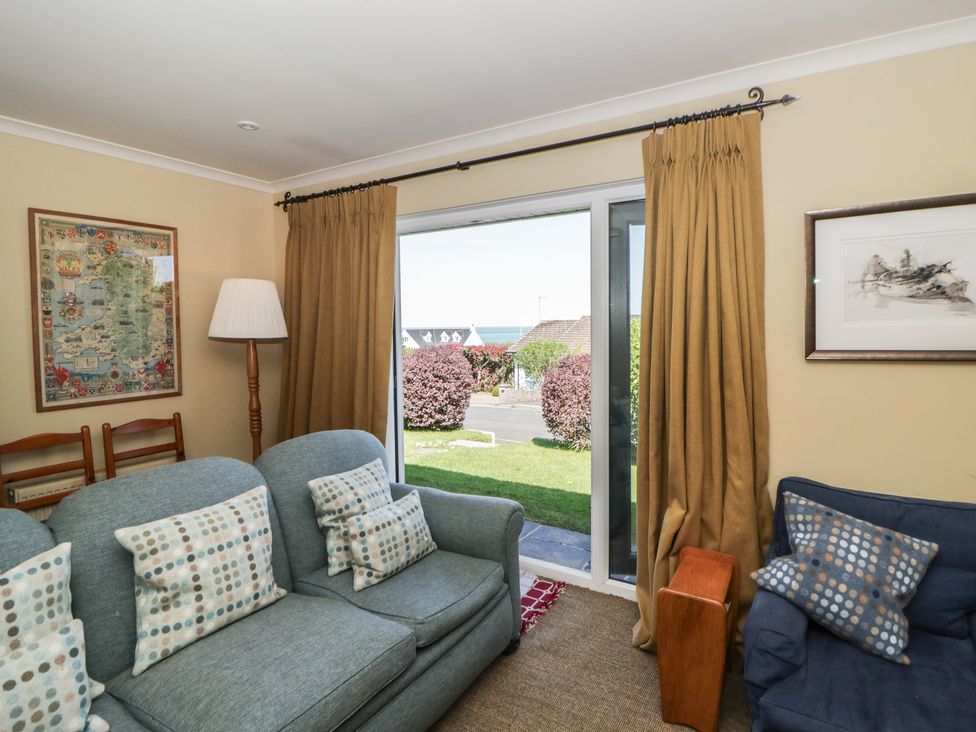 A living room with a sofa and armchair at Dolwylan in Newport, Pembrokeshire