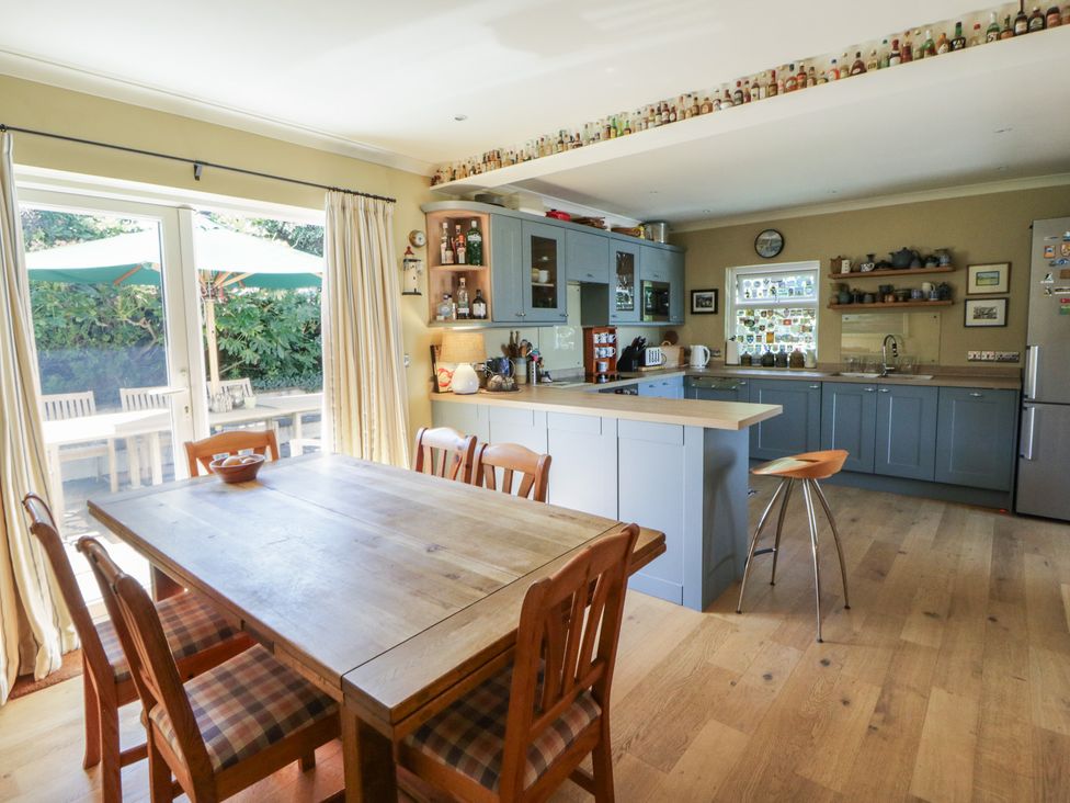 A kitchen with a dining table and chairs at Dolwylan Newport, Pembrokeshire