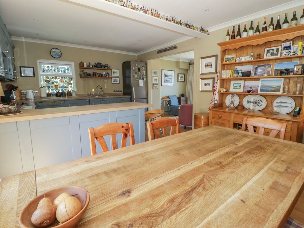 A kitchen with a dining table and chairs at Dolwylan, Newport, Pembrokeshire