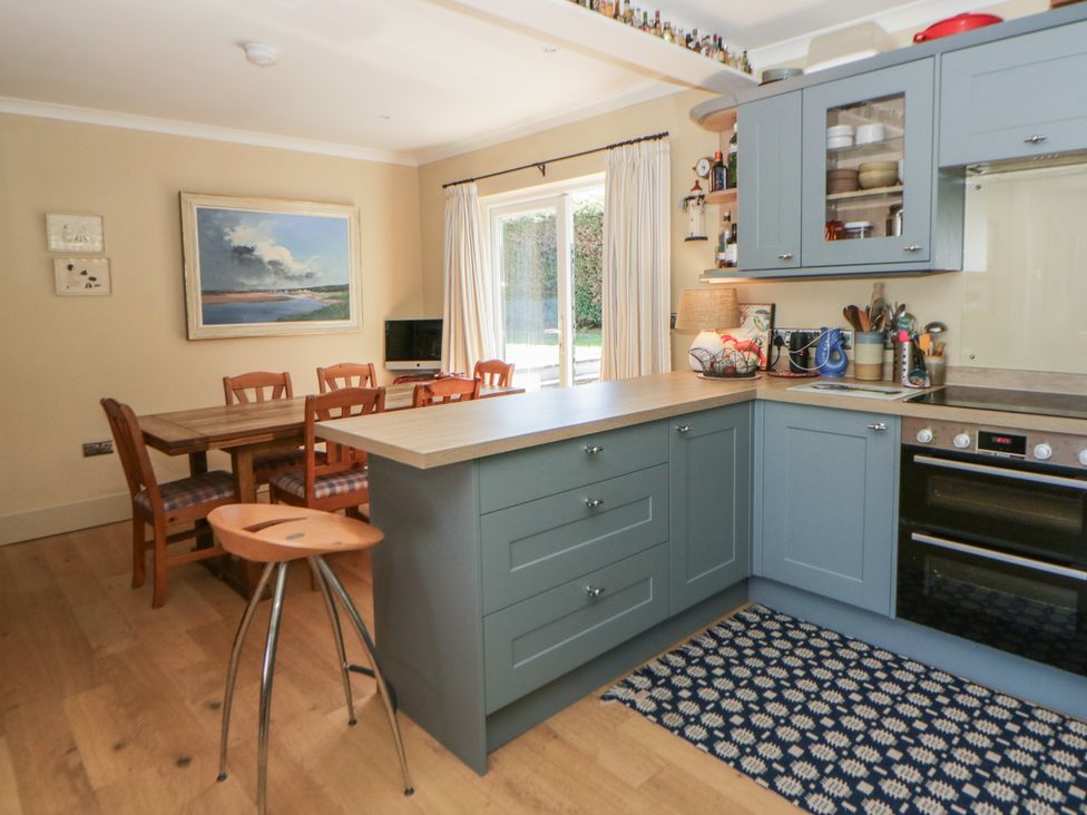 A kitchen with dining area and cooking appliances at Dolwylan Newport, Pembrokeshire