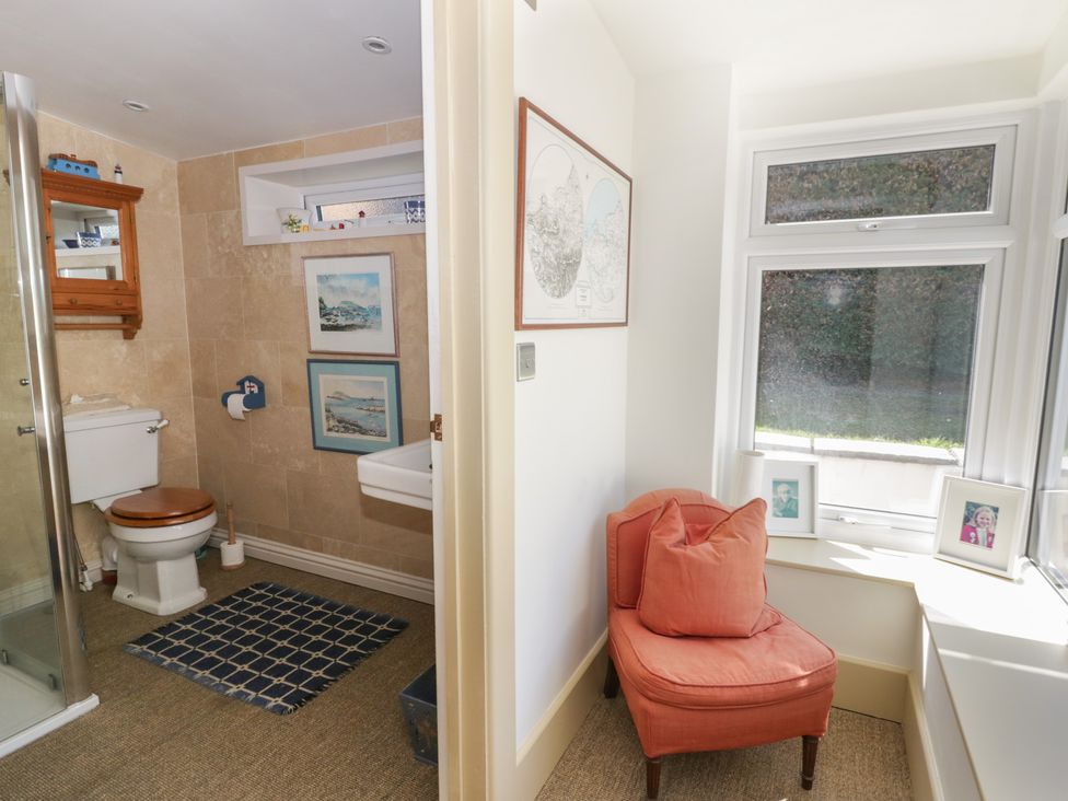 A bathroom with a shower, toilet, and sink at Dolwylan in Newport, Pembrokeshire