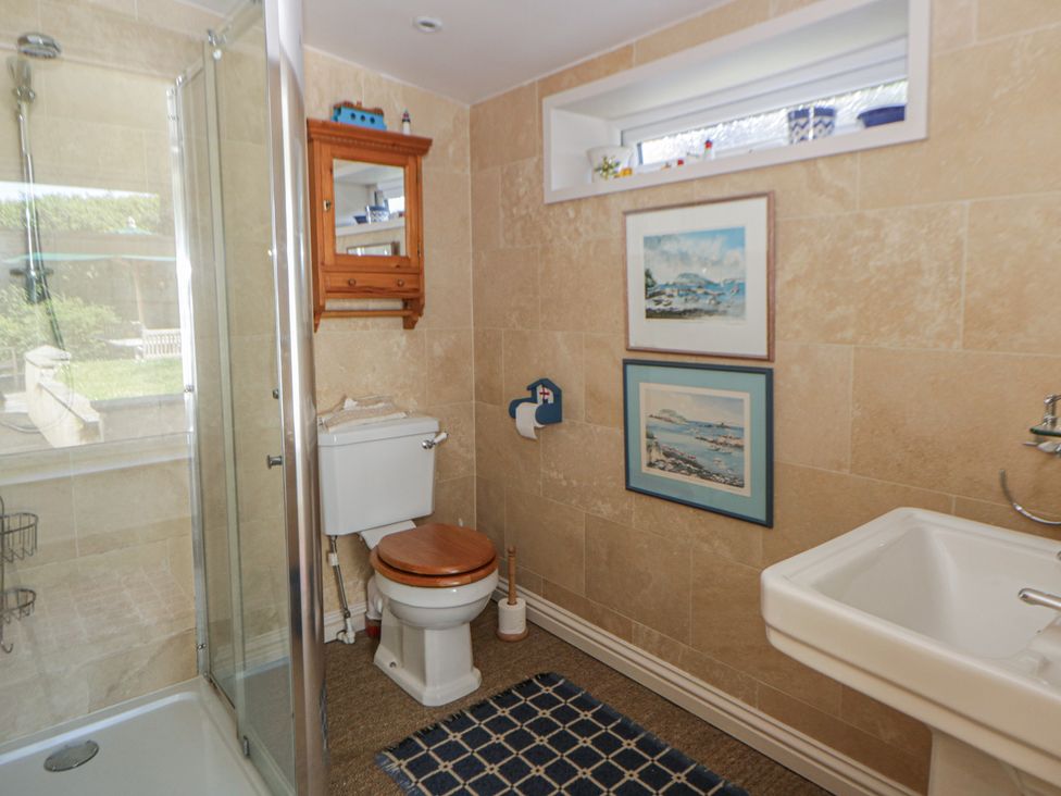 A bathroom with shower, toilet, and sink at Dolwylan in Newport, Pembrokeshire