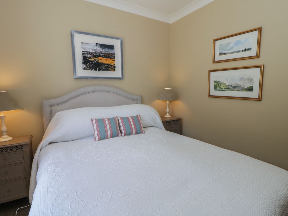 A bedroom with a bed and artwork at Dolwylan Newport, Pembrokeshire
