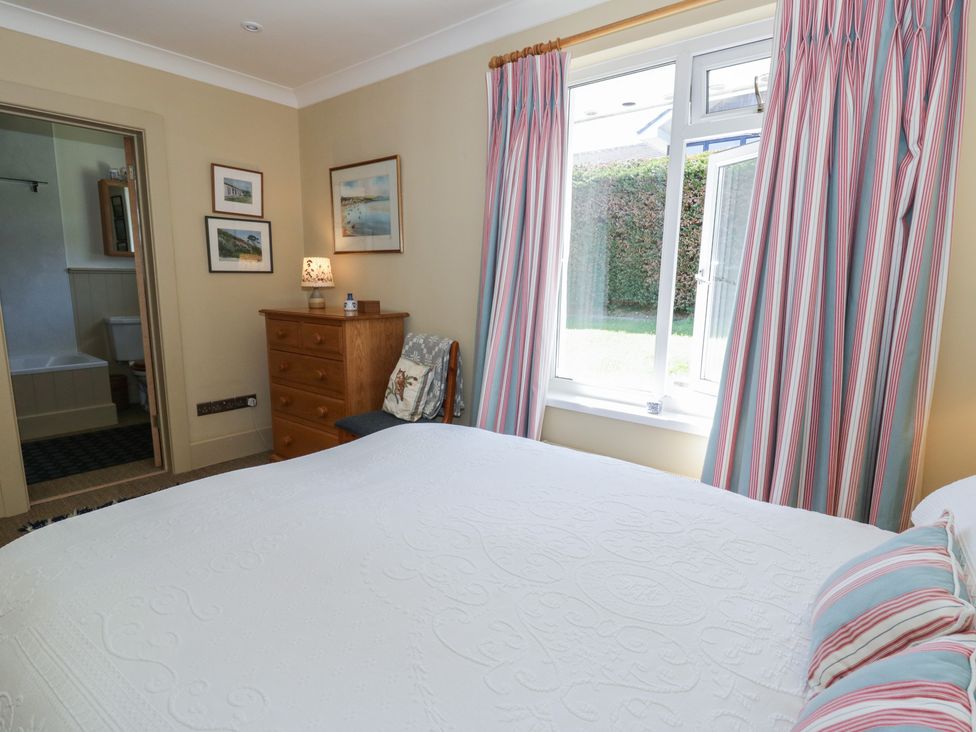 A bedroom with a bed and dressing table at Dolwylan in Newport, Pembrokeshire
