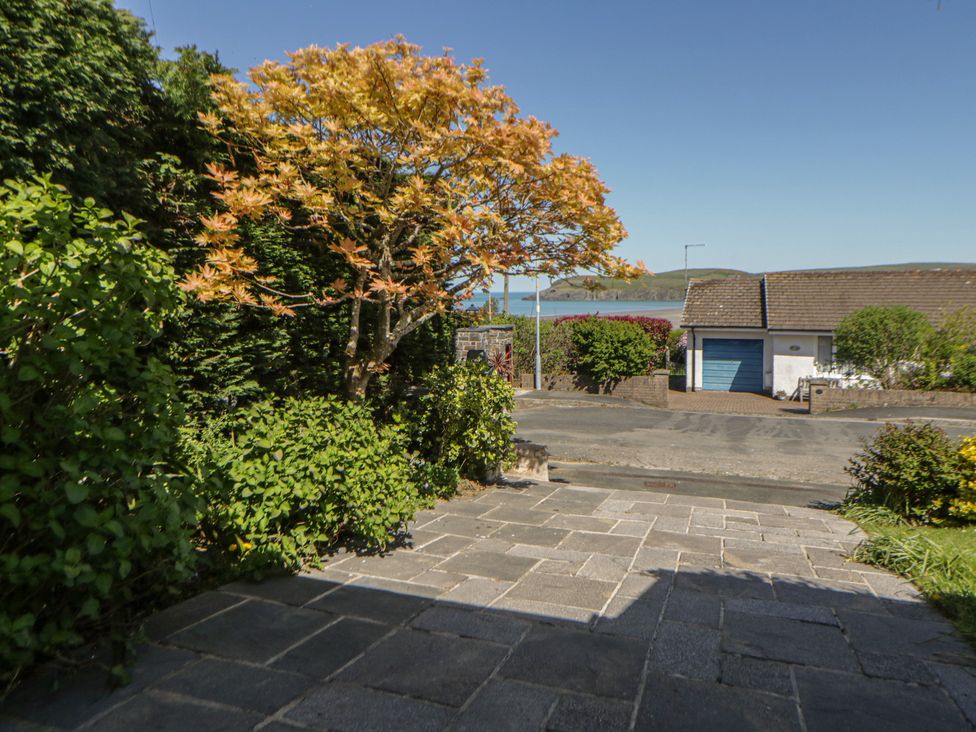 A view from a property featuring a tree and pavement at Dolwylan Newport, Pembrokeshire