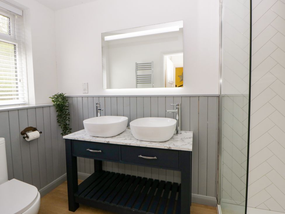 A bathroom with a sink and shower at Delyn Aur in Tresaith, Ceredigion