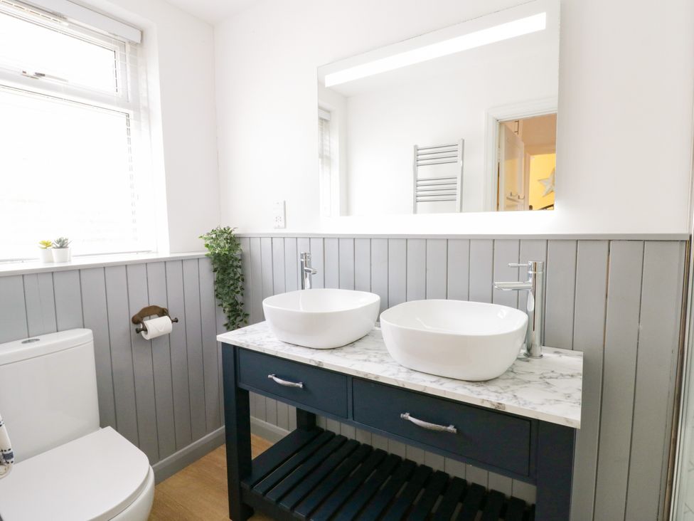 A bathroom with sink and toilet at Delyn Aur Tresaith, Ceredigion