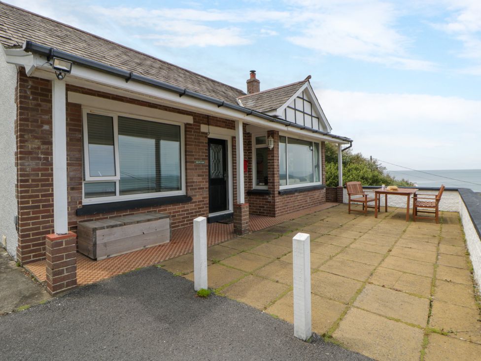 An outdoor area with a table and chairs at Delyn Aur in Tresaith, Ceredigion