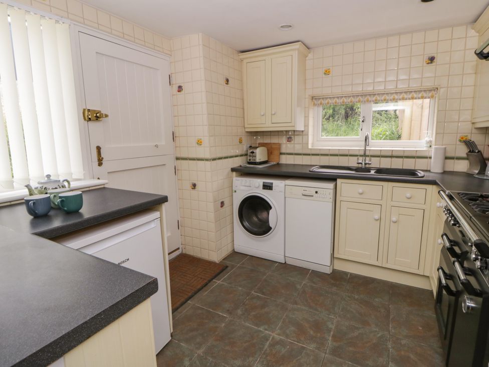 A kitchen with appliances and cabinets at Little Barn Cottage in Dinas Cross, Pembrokeshire