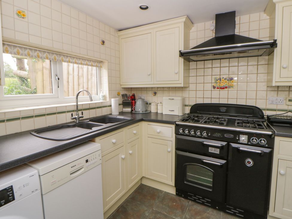 A kitchen with a stove and sink at Little Barn Cottage in Dinas Cross, Pembrokeshire