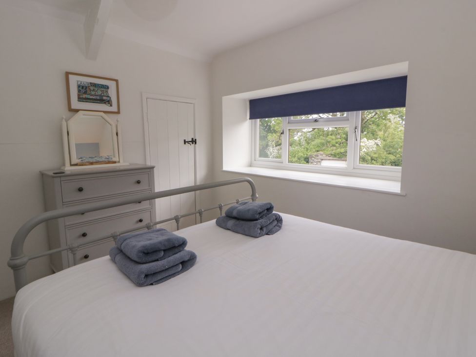 A bedroom with a bed and dresser at Little Barn Cottage Dinas Cross Pembrokeshire