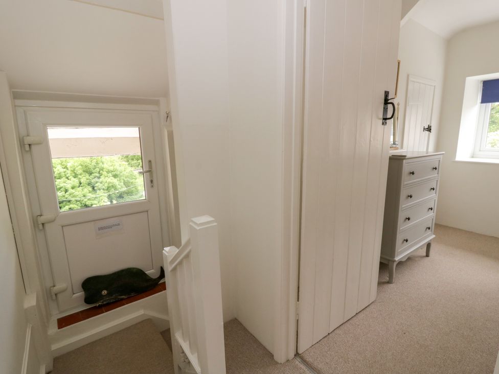 A hallway with a door and window at Little Barn Cottage Dinas Cross Pembrokeshire