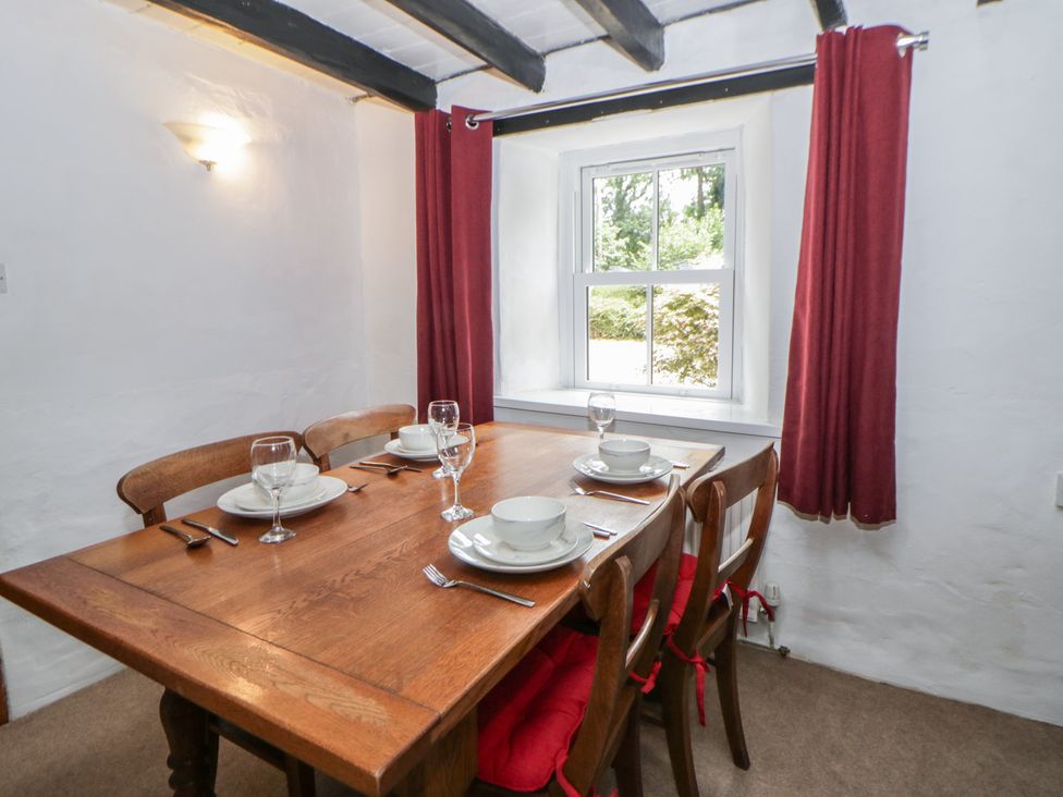 A dining room with a wooden table and chairs at Panteg, Cardigan Llangoedmor Cardigan
