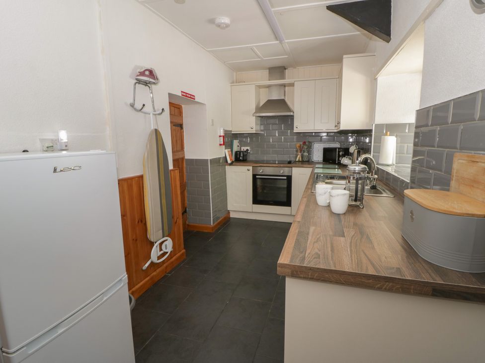 A kitchen with refrigerator, oven, and sink at Panteg, Cardigan Llangoedmor Cardigan