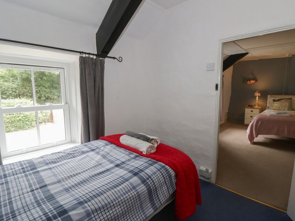 A bedroom with a bed and window at Panteg, Cardigan Llangoedmor Cardigan