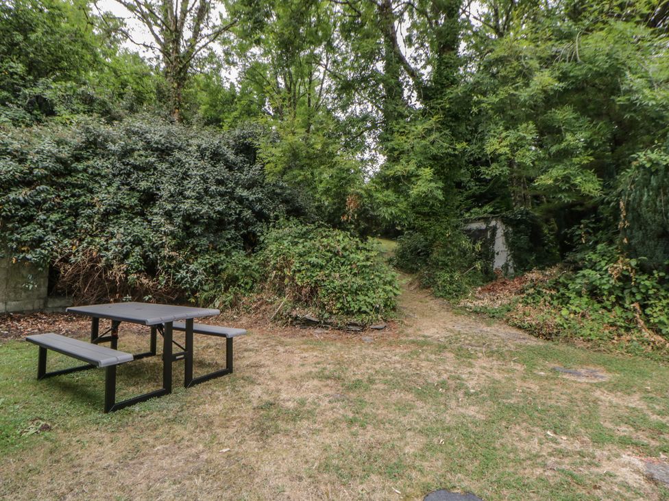 A picnic table with benches in a garden at Panteg, Cardigan Llangoedmor Cardigan