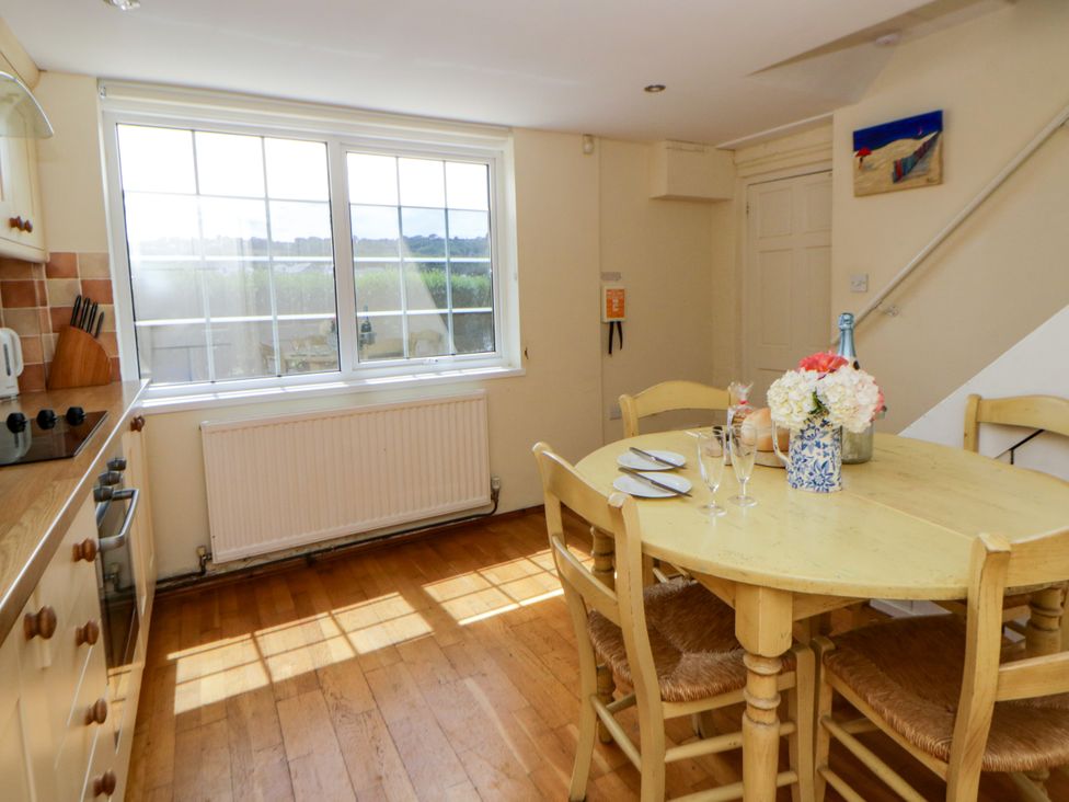 A kitchen with a dining table and chairs at Beach Retreat in Aberporth