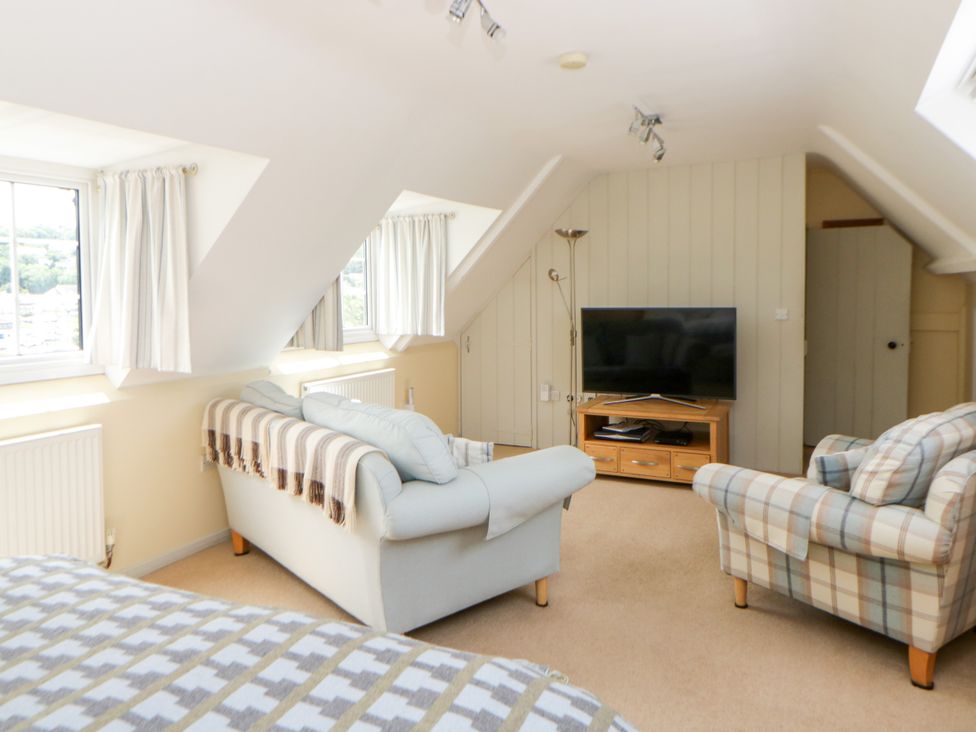 A living room with a sofa and television at Beach Retreat in Aberporth