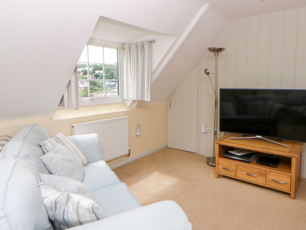 A living room with a sofa and television at Beach Retreat in Aberporth