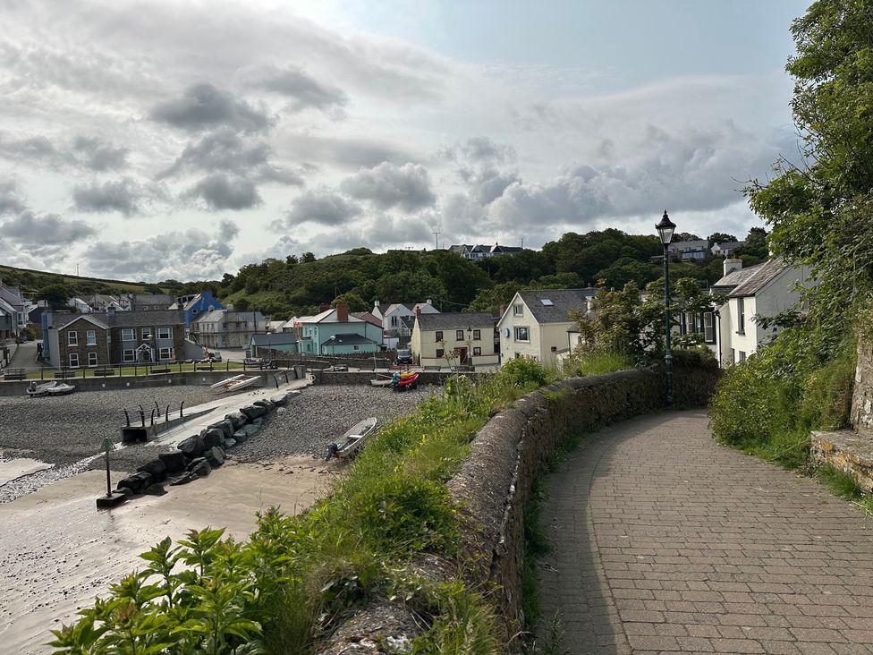 A coastal view with houses and boats at Beach Cottage in Little Haven, Pembrokeshire
