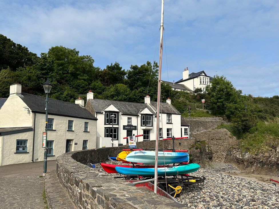 A view of the Swan Inn and kayaks at Beach Cottage in Little Haven, Pembrokeshire