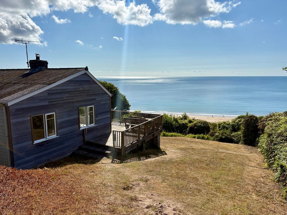 A house with a deck overlooking the sea at Beach Cove in Freshwater East, Pembrokeshire