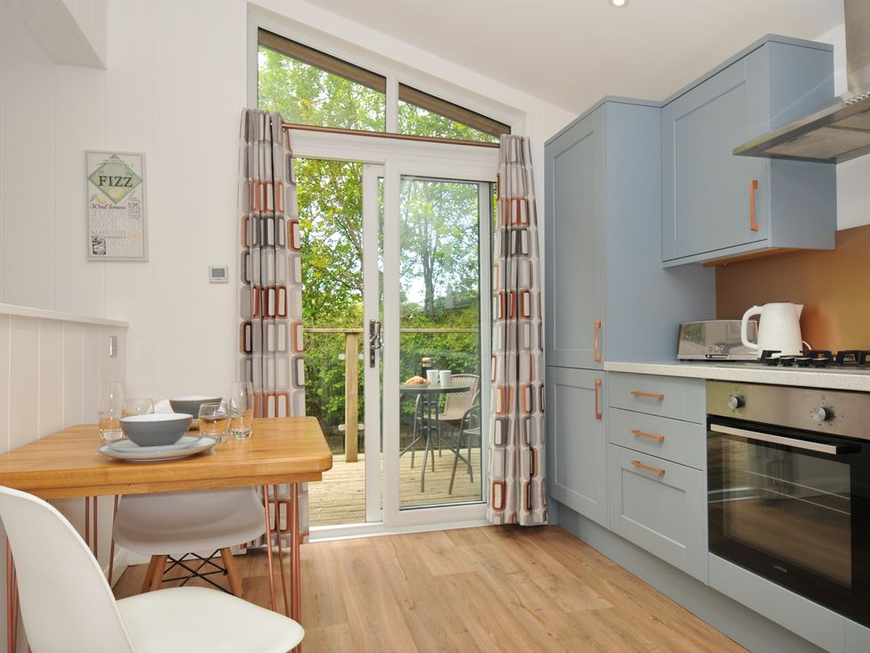 A kitchen with a table and chairs at The Hideout in Lanreath