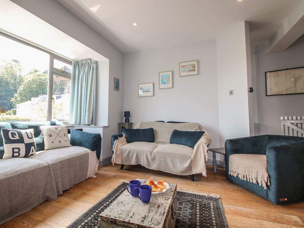 A living room with a sofa and armchair at Anchor Cottage in Salcombe