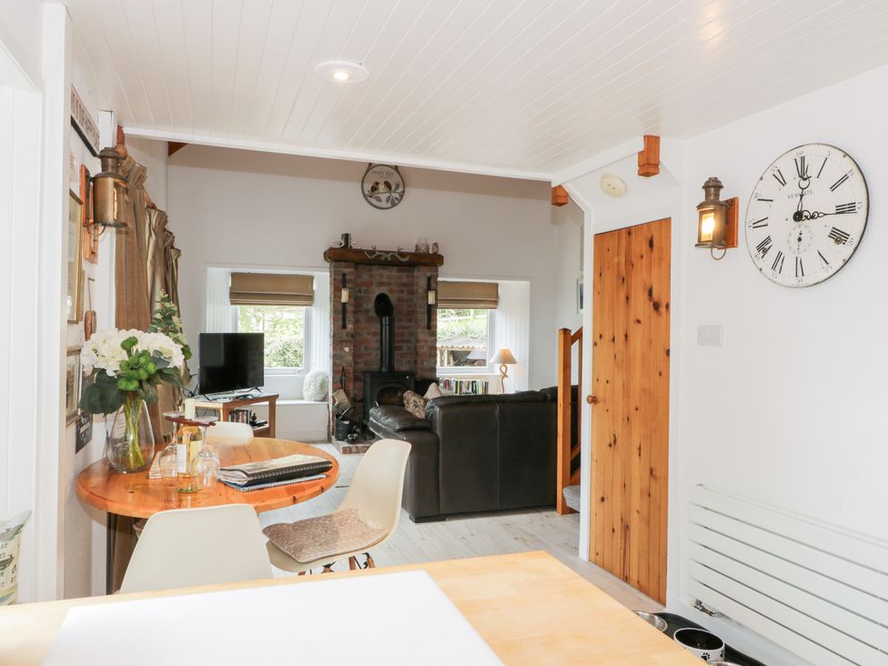 A living room with a fireplace and sofa at The Barn in Rockcliffe