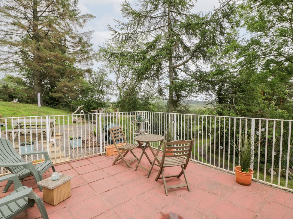 An outdoor patio with a table and chairs at The Barn in Rockcliffe