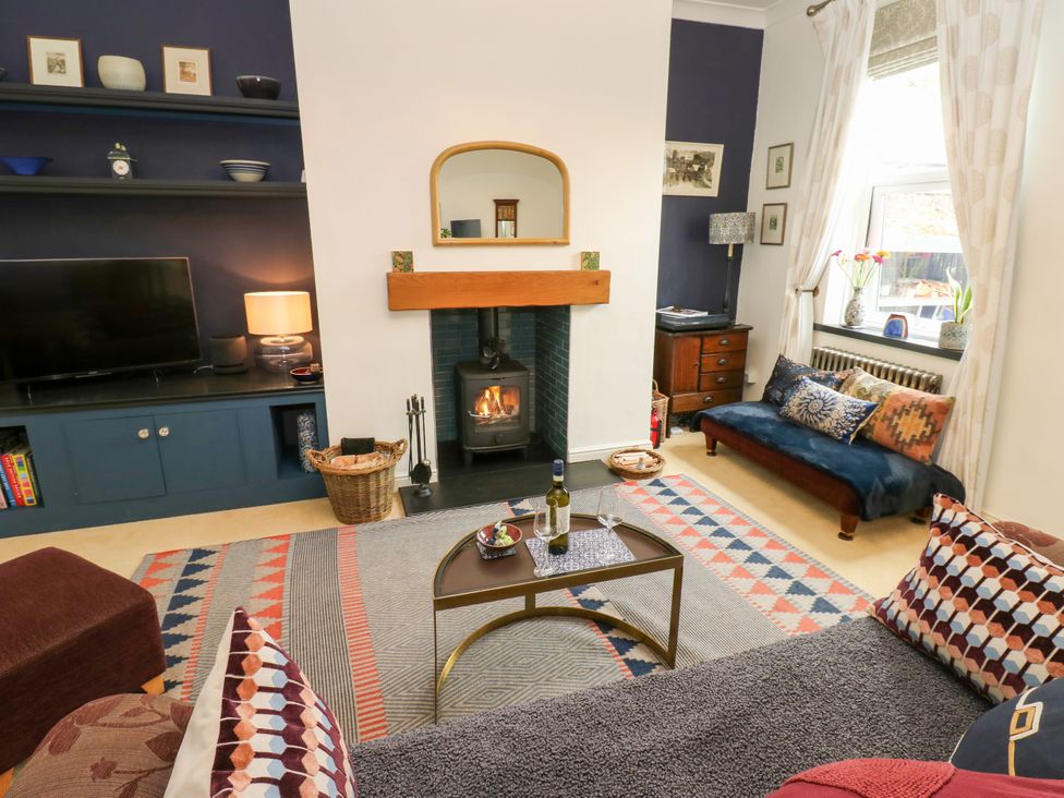 A living room with a fireplace and television at 4 Ford Street Lanchester