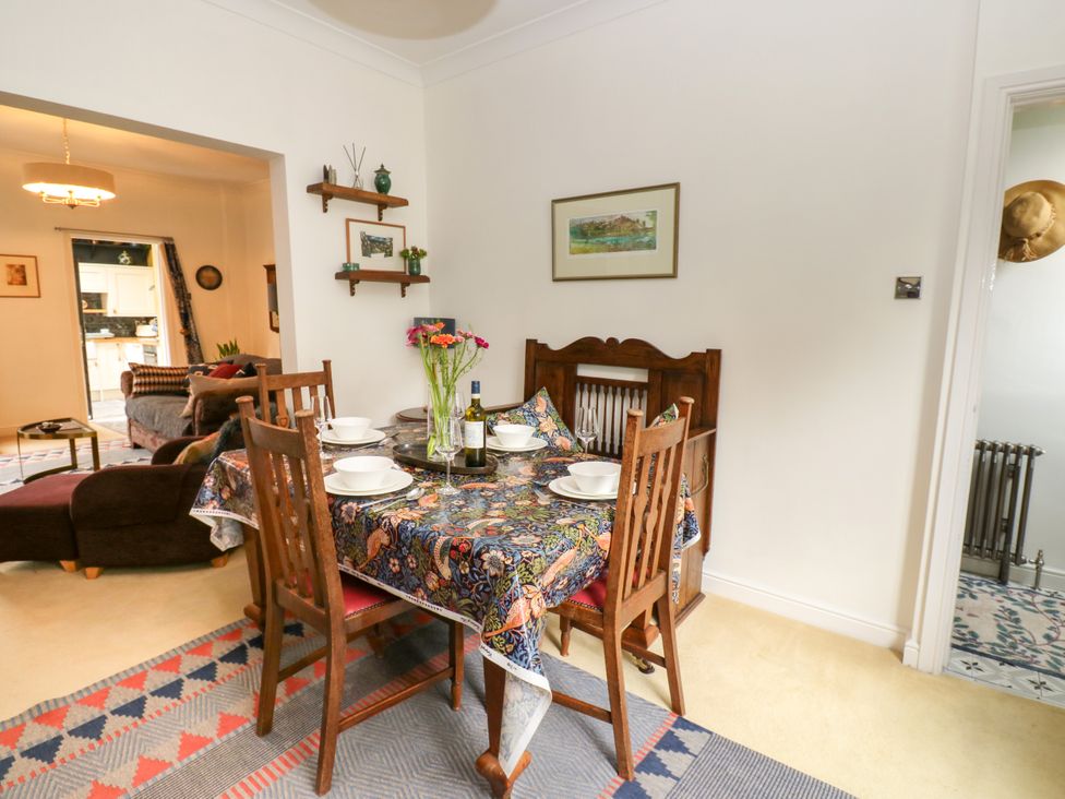 A dining room with a table set for meals at 4 Ford Street Lanchester