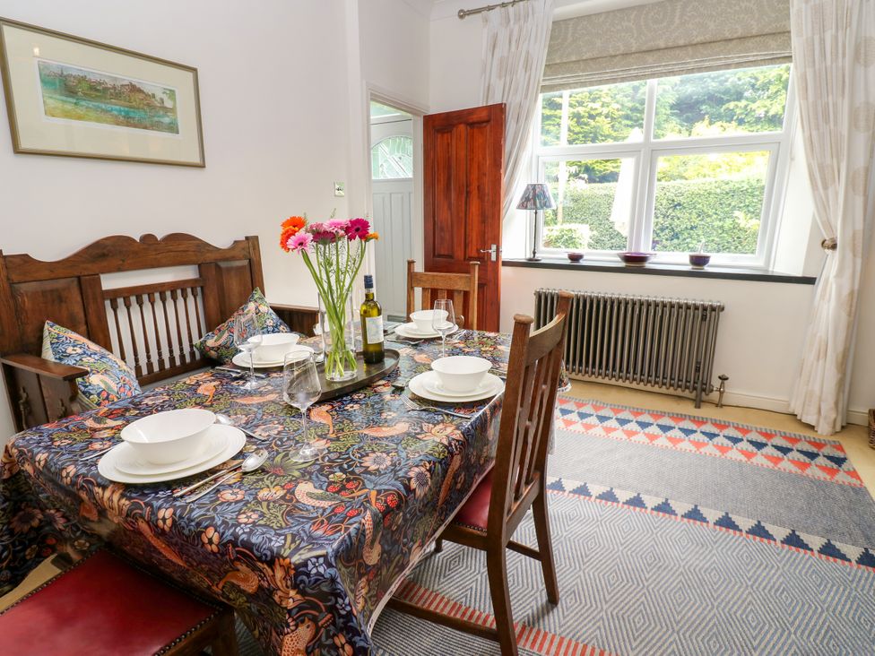 A dining room with a table set for a meal at 4 Ford Street in Lanchester