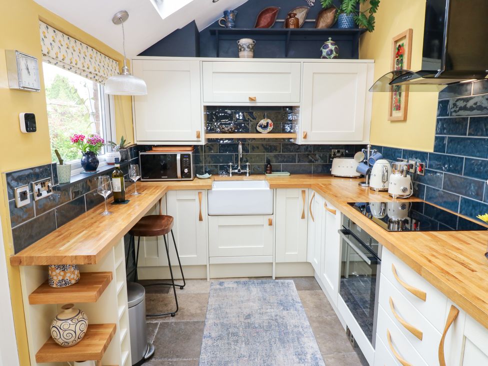 A kitchen with a sink, countertop, and appliances at 4 Ford Street Lanchester