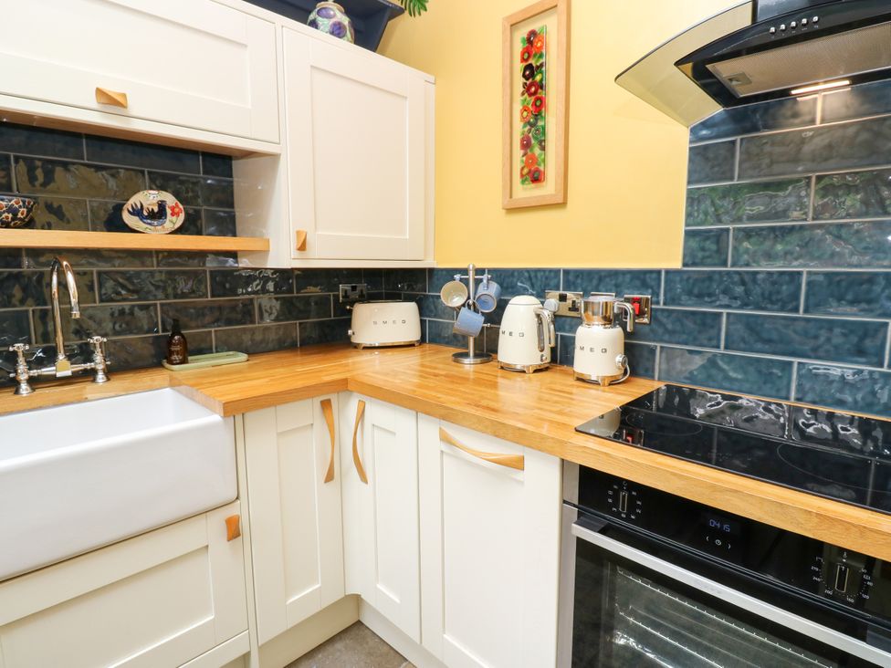 A kitchen with a sink and appliances at 4 Ford Street Lanchester
