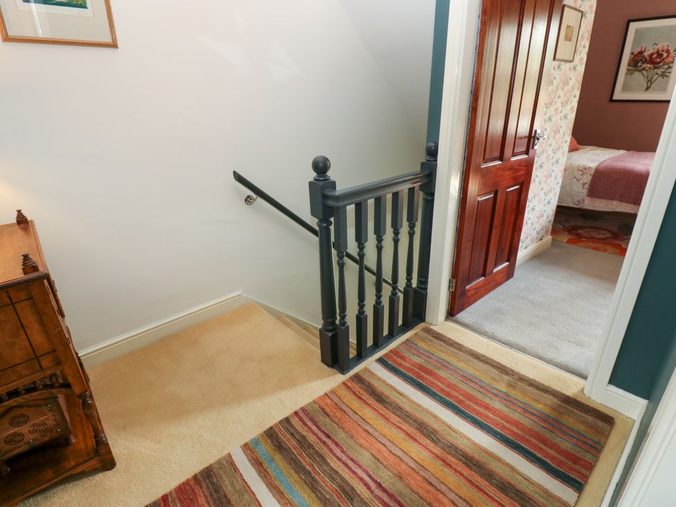 A hallway with a staircase and a door at 4 Ford Street Lanchester