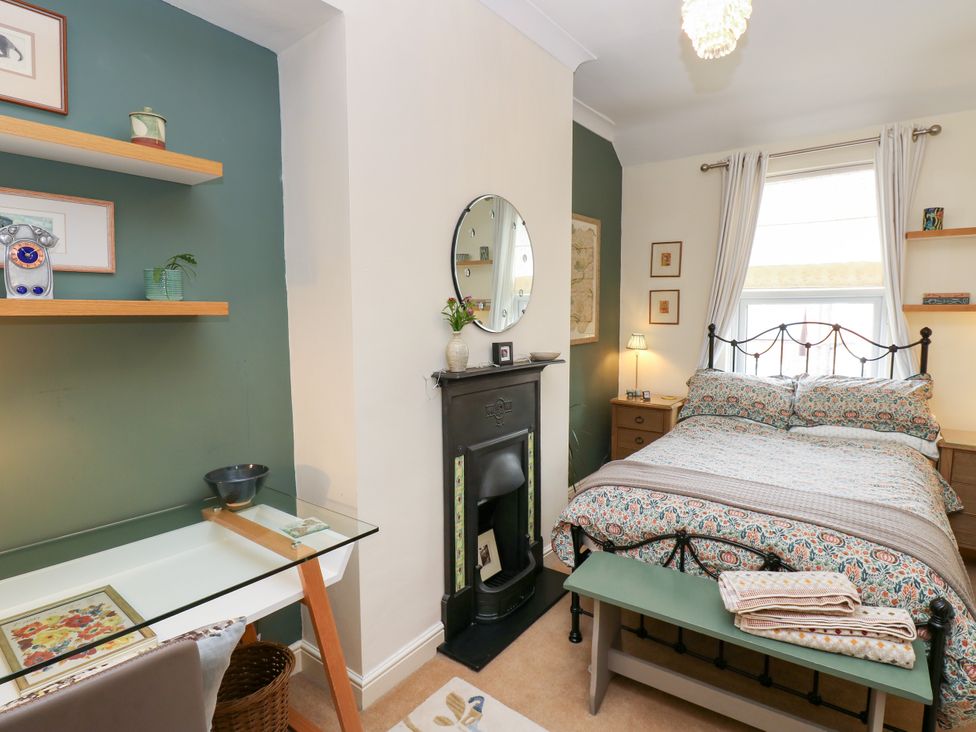 A bedroom with a bed, desk, and shelves at 4 Ford Street, Lanchester