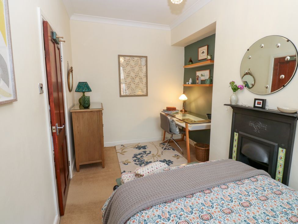A bedroom with a bed, desk, and chair at 4 Ford Street Lanchester