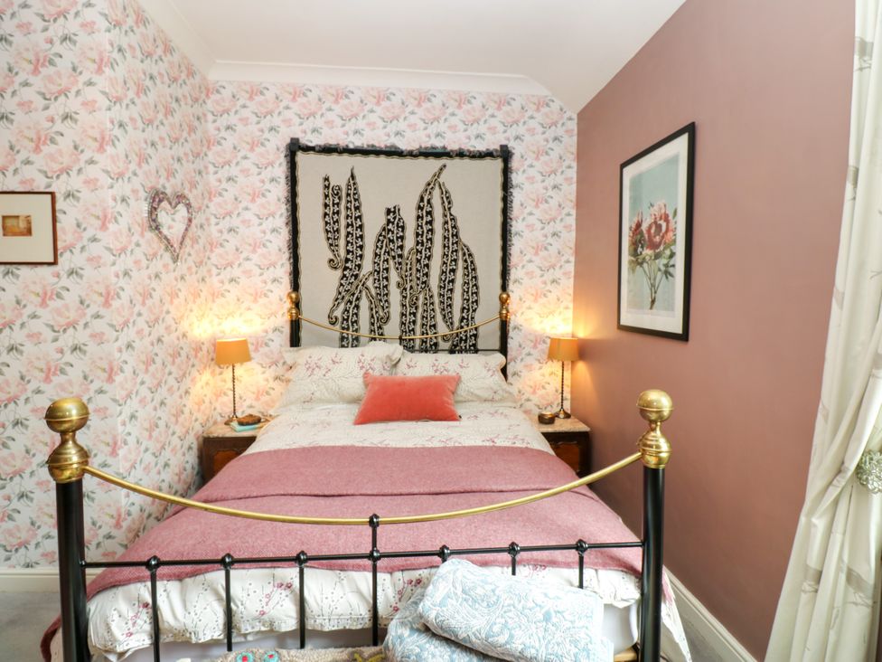 A bedroom with a bed and bedside lamps at 4 Ford Street in Lanchester