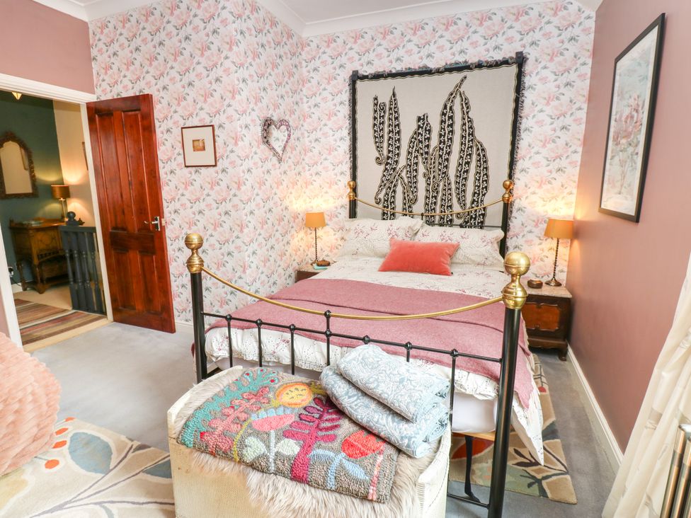A bedroom with a bed and nightstands at 4 Ford Street in Lanchester