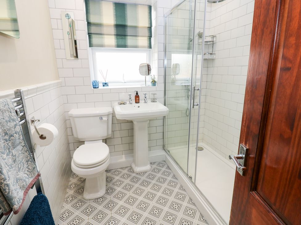 A bathroom featuring a shower, sink, and toilet at 4 Ford Street in Lanchester