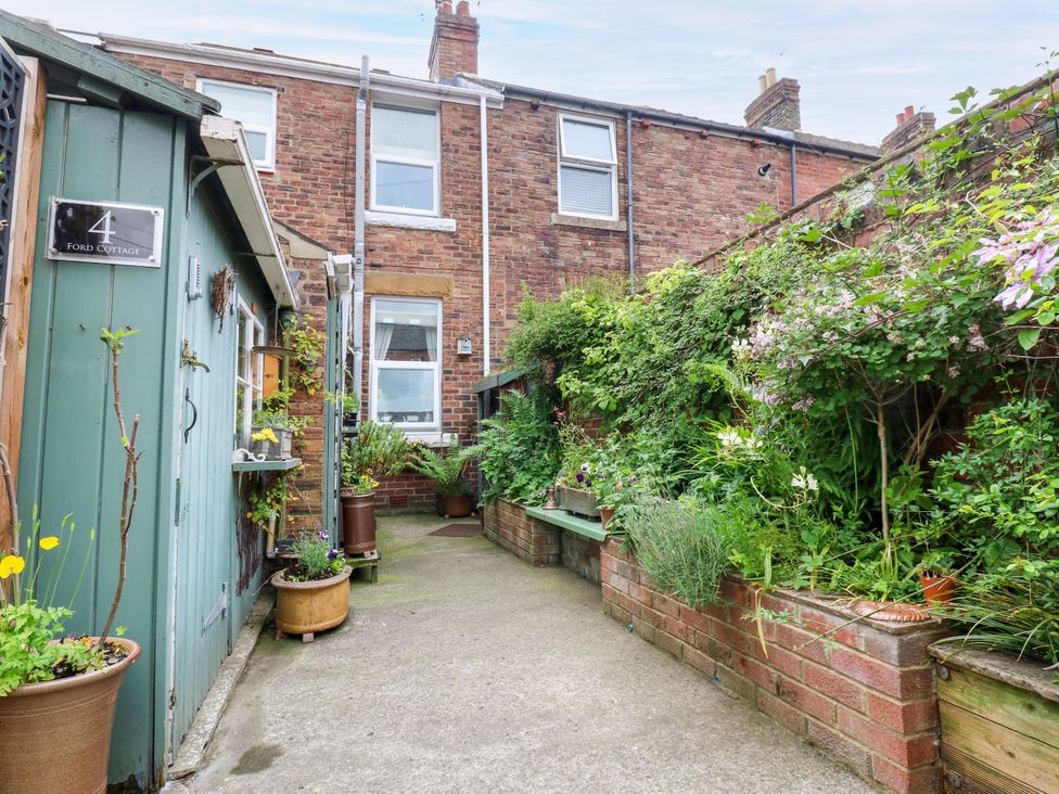 A garden with plants and pathway at 4 Ford Street in Lanchester